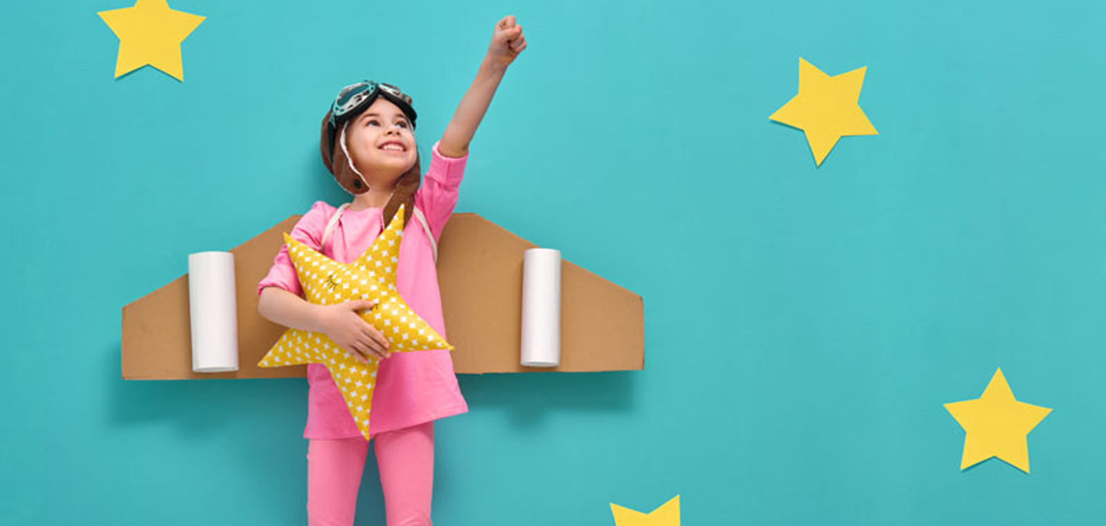 Child playing with cardboard airplane